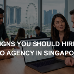 Business professionals review SEO analytics on a laptop inside a Singapore office overlooking the Marina Bay skyline.