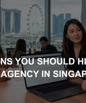 Business professionals review SEO analytics on a laptop inside a Singapore office overlooking the Marina Bay skyline.