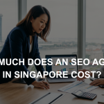 Singapore business professionals reviewing data charts on a laptop in an office overlooking the city skyline.